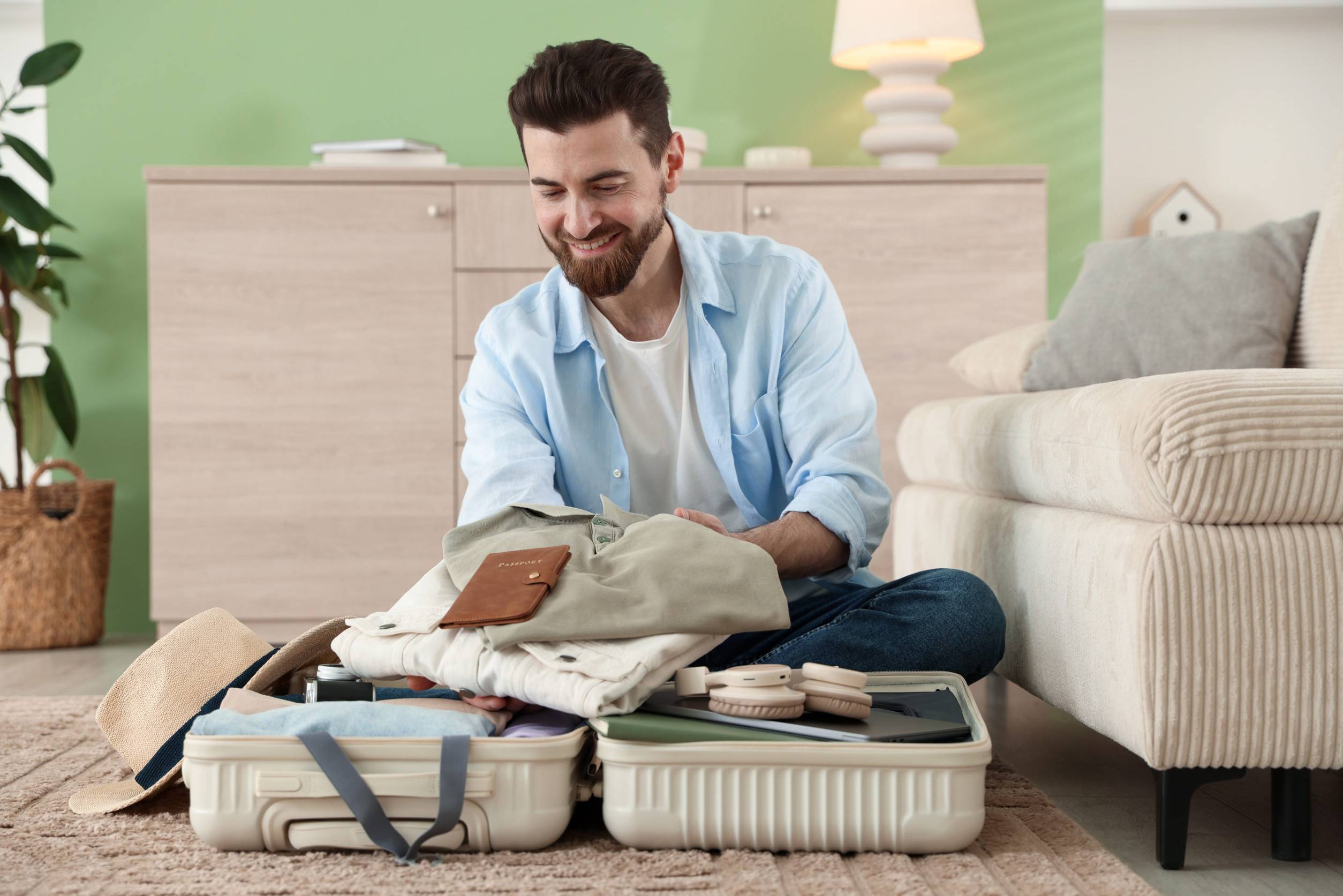 A Man Packing His Belongings Into Luggage