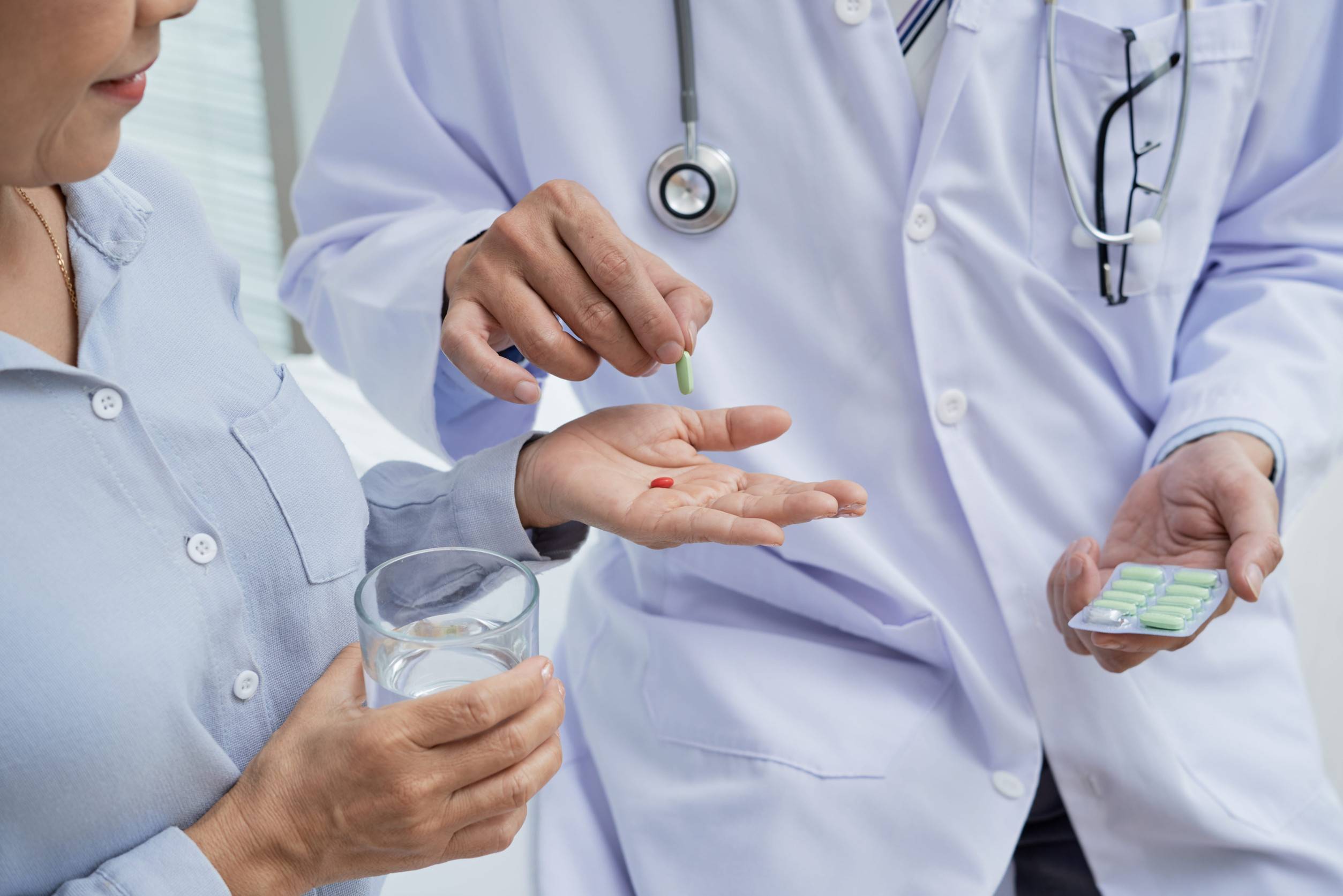 Doctor giving medicine to a patient